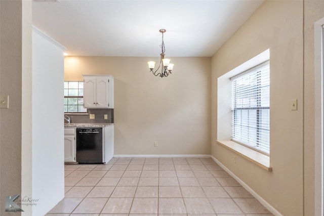kitchen featuring a notable chandelier, light countertops, black dishwasher, white cabinetry, and tasteful backsplash