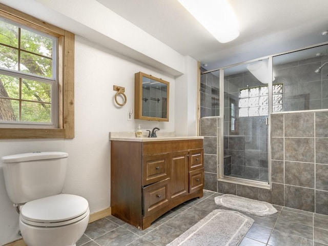 full bathroom with toilet, a tile shower, tile patterned flooring, and vanity