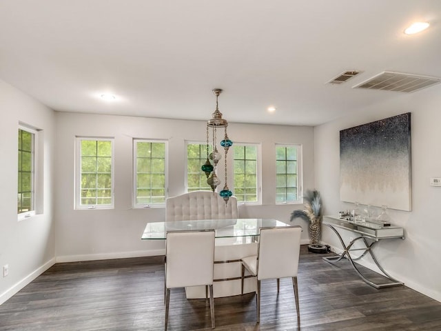 dining room featuring baseboards, visible vents, and a wealth of natural light