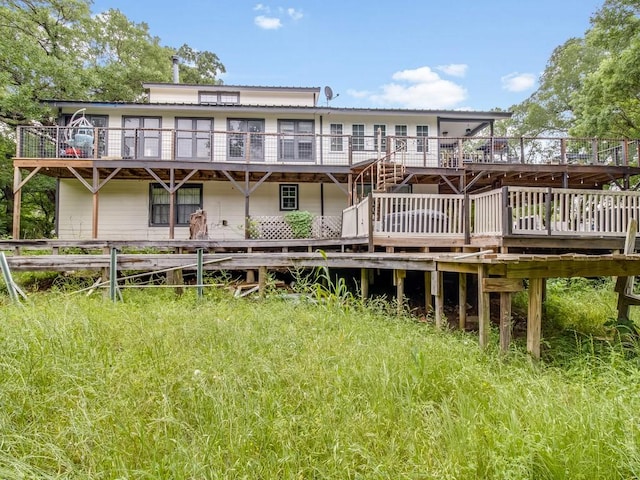 rear view of house with metal roof and a deck