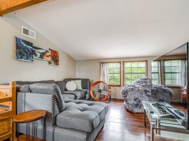 living area with visible vents, lofted ceiling, and wood finished floors