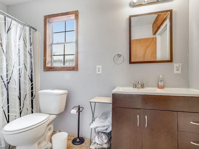 bathroom featuring vanity, curtained shower, and toilet