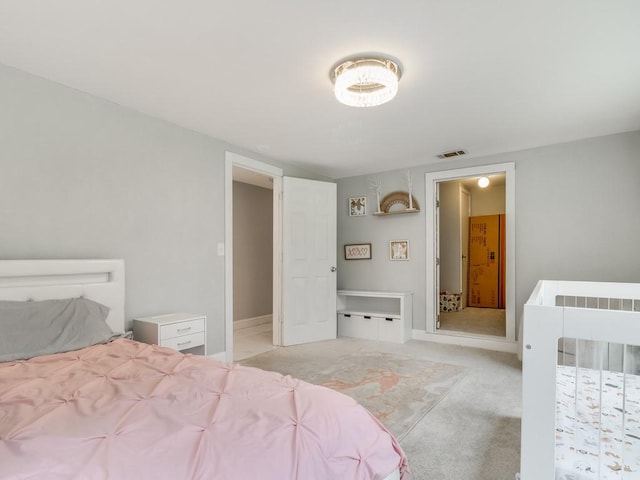 bedroom with light colored carpet, baseboards, and visible vents