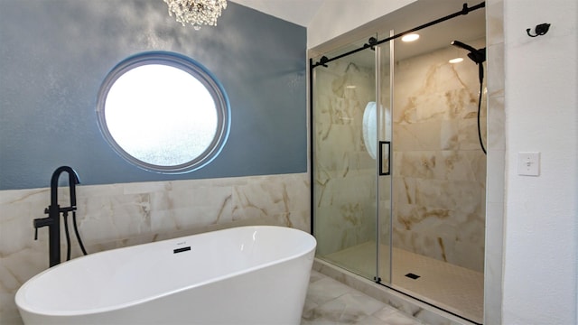 full bathroom featuring tile walls, a soaking tub, a stall shower, and marble finish floor
