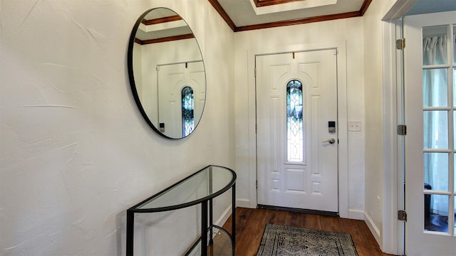 foyer entrance featuring crown molding, baseboards, and dark wood-type flooring