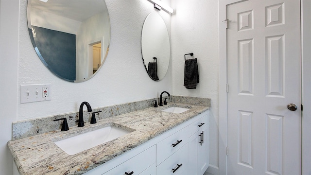 bathroom featuring double vanity and a sink