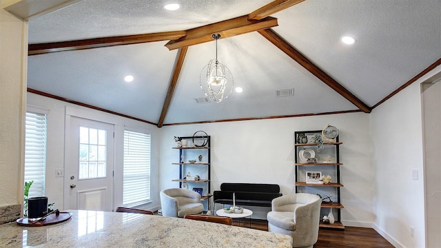 living area featuring a textured ceiling, lofted ceiling with beams, visible vents, and dark wood-type flooring