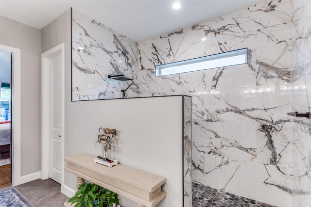 interior space with a marble finish shower and a wealth of natural light