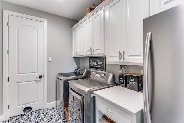 laundry room with baseboards, cabinet space, and washer and dryer