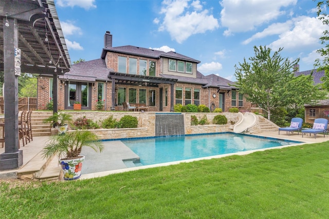 rear view of house with brick siding, an outdoor pool, a pergola, and a patio
