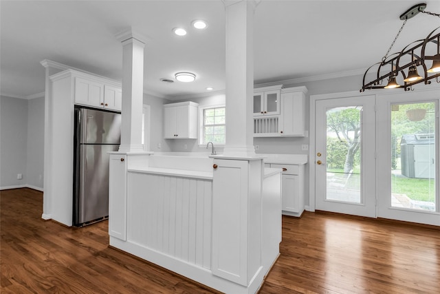 414 Jolee St, Richardson, TX 75080 - kitchen with ornate columns, freestanding refrigerator, light countertops, and ornamental molding