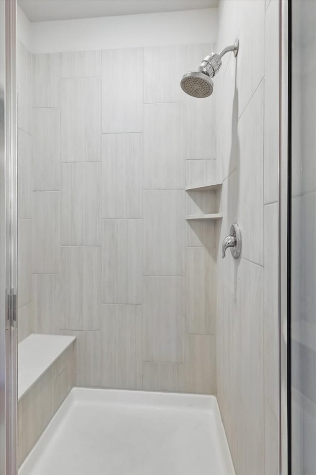 full bath with a tile shower