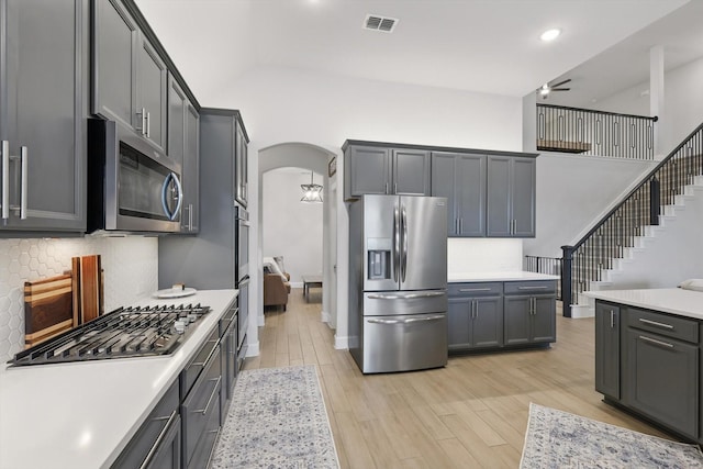 kitchen with light countertops, a ceiling fan, appliances with stainless steel finishes, and visible vents