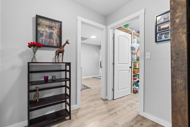 bathroom featuring wooden walls, vanity, wood finished floors, and visible vents