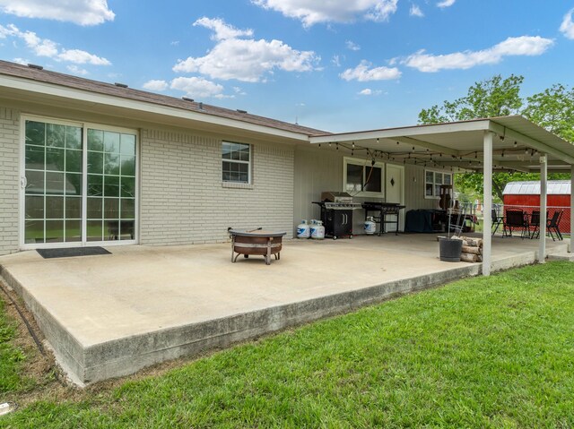 view of patio / terrace featuring a storage shed, fence, outdoor dining area, and an outdoor structure