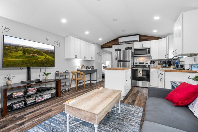 living room featuring recessed lighting, vaulted ceiling, and wood finished floors