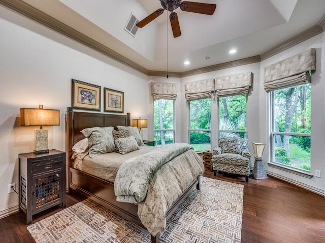bedroom featuring visible vents, crown molding, dark wood-style floors, and multiple windows