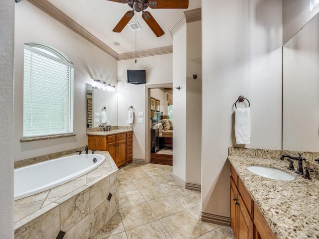 ensuite bathroom featuring crown molding, a ceiling fan, connected bathroom, a bath, and a sink