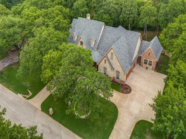 birds eye view of property with a view of trees