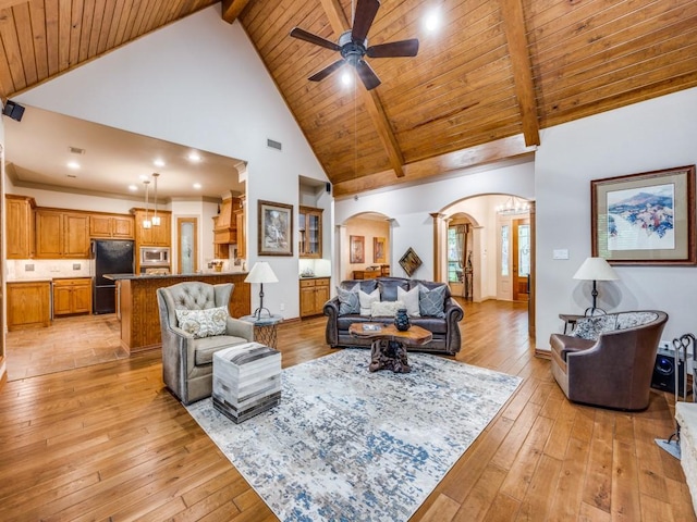 living room featuring wood ceiling, a ceiling fan, arched walkways, high vaulted ceiling, and beamed ceiling