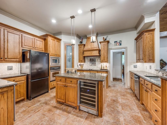 kitchen with beverage cooler, appliances with stainless steel finishes, decorative backsplash, and a sink