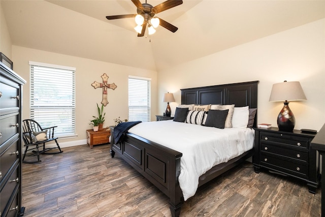 bedroom featuring baseboards, dark wood finished floors, multiple windows, and vaulted ceiling