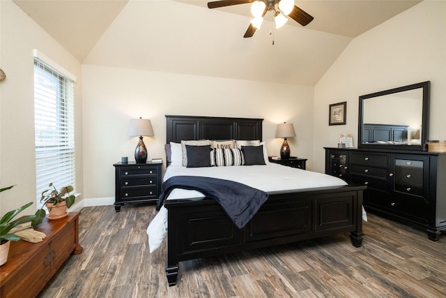 bedroom featuring wood finished floors, a ceiling fan, baseboards, and lofted ceiling
