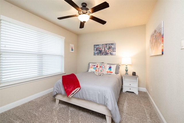 carpeted bedroom featuring baseboards and a ceiling fan