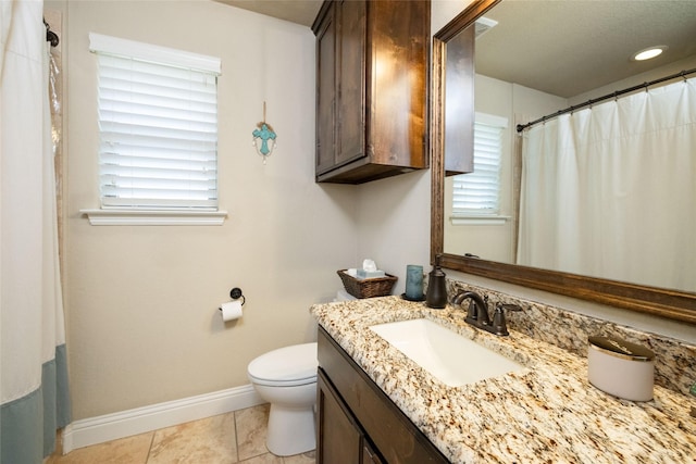 full bathroom with toilet, baseboards, tile patterned floors, and vanity