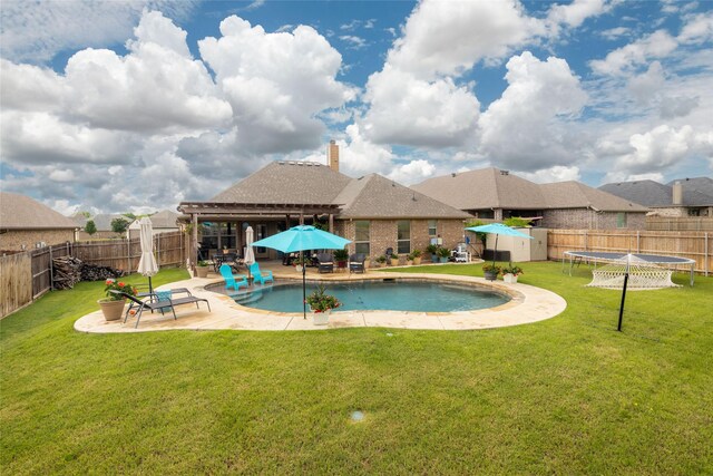 view of swimming pool featuring a fenced backyard, a trampoline, a lawn, and a patio