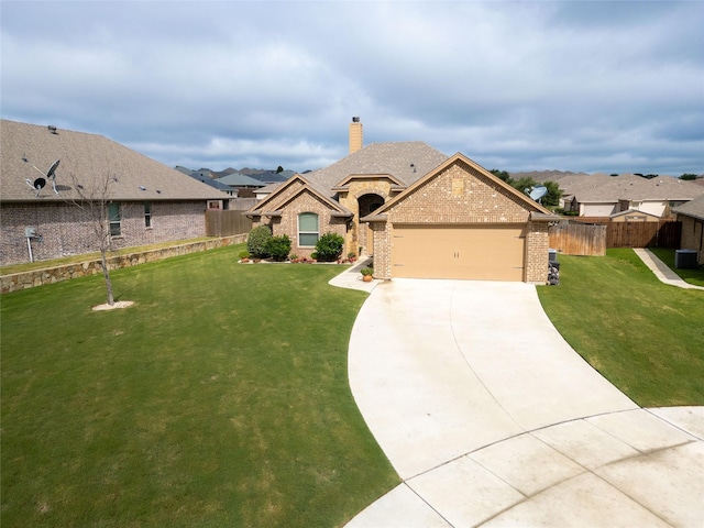 french country inspired facade with a garage, a front lawn, fence, brick siding, and concrete driveway