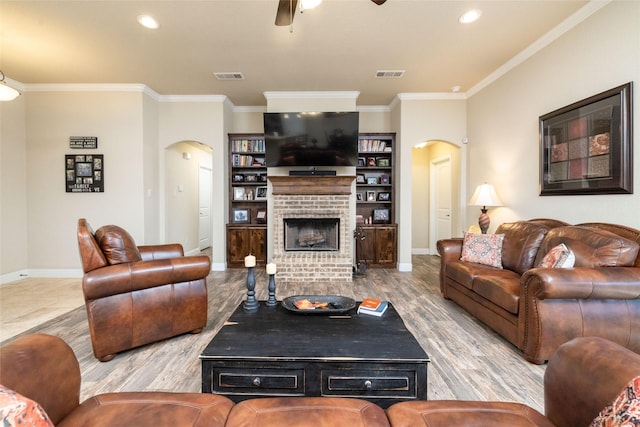 living room with visible vents, arched walkways, and wood finished floors