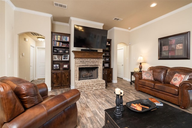 living area featuring crown molding, arched walkways, and visible vents