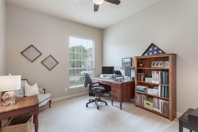 office area featuring light colored carpet, a ceiling fan, baseboards, and a healthy amount of sunlight