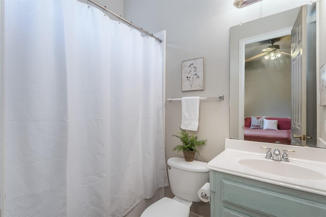 ensuite bathroom with vanity, a ceiling fan, ensuite bathroom, and toilet