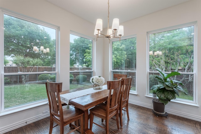 dining area with an inviting chandelier, baseboards, dark wood-style floors, and a healthy amount of sunlight