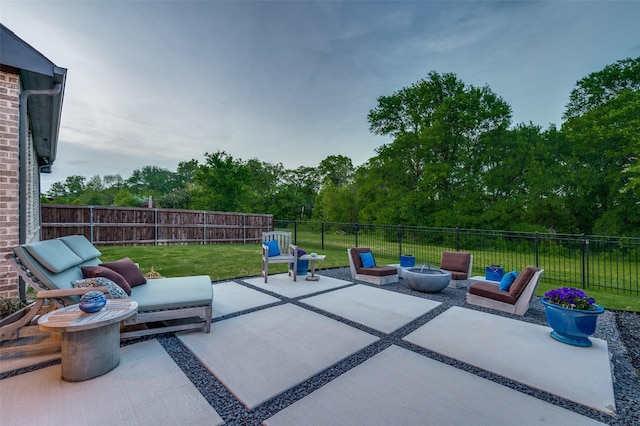 view of patio featuring a fenced backyard and an outdoor living space with a fire pit