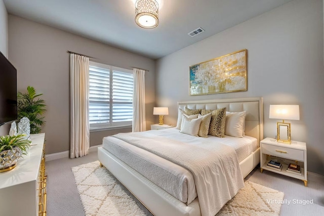 bedroom featuring carpet flooring, baseboards, and visible vents
