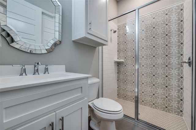 bathroom with vanity, a stall shower, and toilet