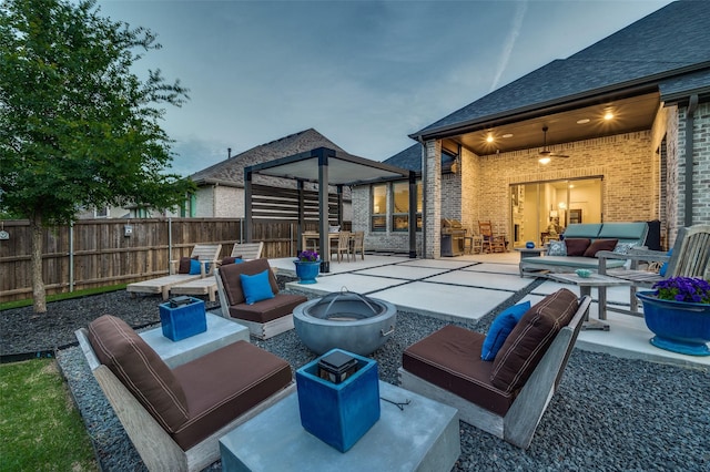 view of patio / terrace featuring a fenced backyard and an outdoor living space with a fire pit