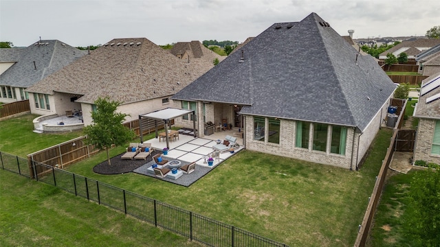 rear view of property featuring a patio, a fenced backyard, roof with shingles, and brick siding