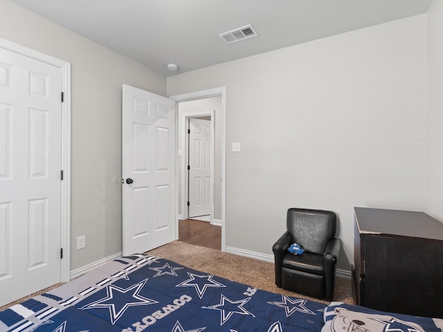 bedroom with visible vents, carpet, and baseboards