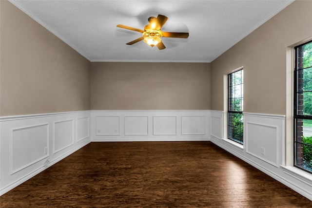 3813 Parkmont Dr, Plano, TX 75023 - empty room featuring ornamental molding, a textured ceiling, dark wood-style floors, a ceiling fan, and wainscoting
