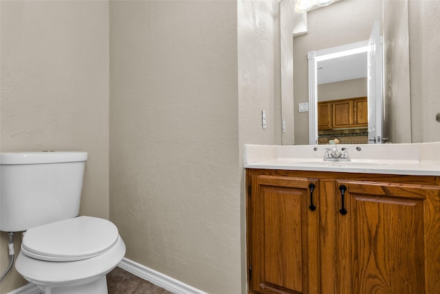3813 Parkmont Dr, Plano, TX 75023 - bathroom with toilet, baseboards, vanity, and a textured wall
