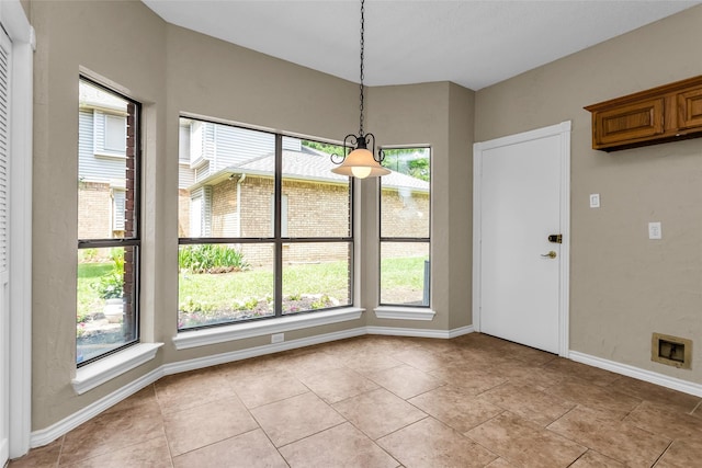 3813 Parkmont Dr, Plano, TX 75023 - unfurnished dining area with baseboards, a healthy amount of sunlight, and light tile patterned floors