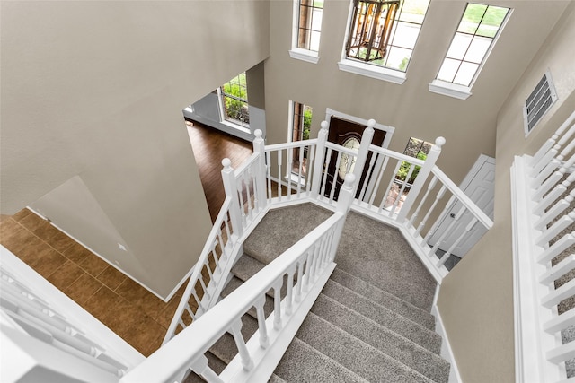 3813 Parkmont Dr, Plano, TX 75023 - stairs with an inviting chandelier, a high ceiling, and plenty of natural light