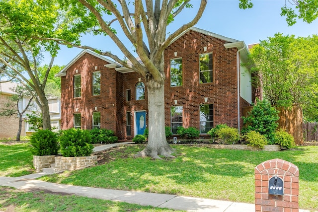 3813 Parkmont Dr, Plano, TX 75023 - traditional-style house with brick siding, fence, and a front yard