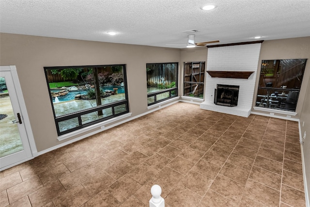 3813 Parkmont Dr, Plano, TX 75023 - unfurnished living room featuring a fireplace, a textured ceiling, a ceiling fan, and visible vents