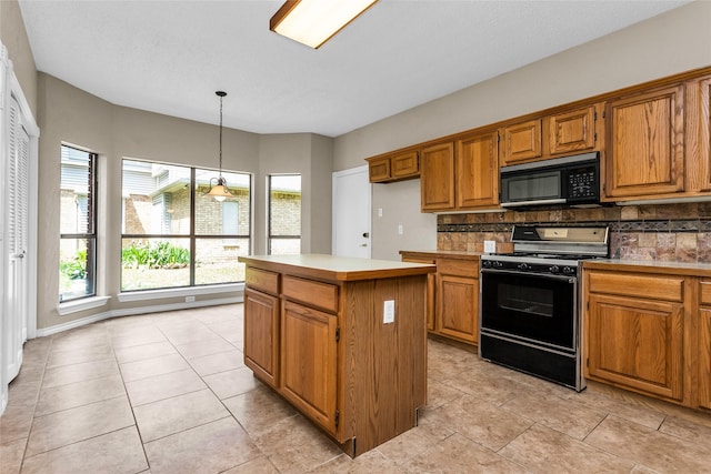 3813 Parkmont Dr, Plano, TX 75023 - kitchen with brown cabinetry, range with gas cooktop, decorative backsplash, a kitchen island, and black microwave