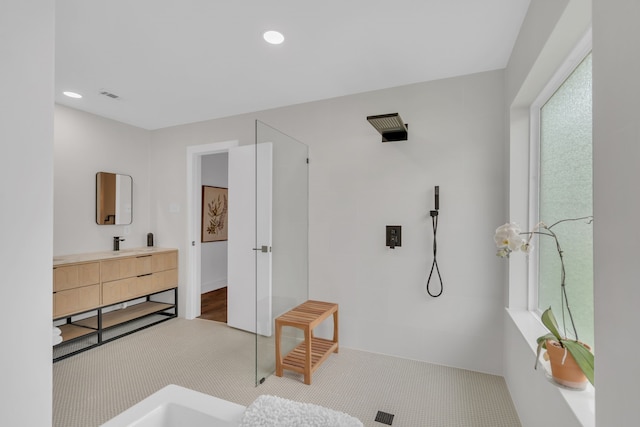 full bathroom featuring vanity, walk in shower, recessed lighting, and visible vents